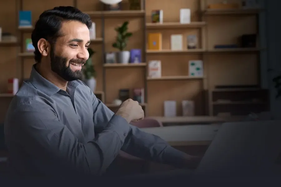 A SNHU student smiles as he studies his Bachelor of Business Administration in Entrepreneurship online from India.