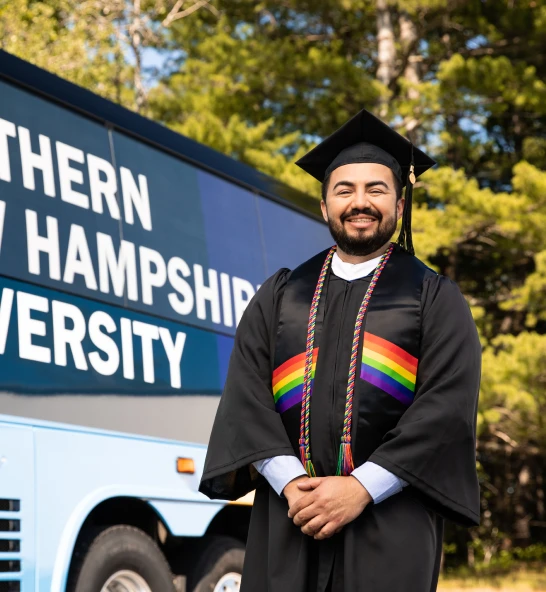 Graduate from SNHU wearing a cap and gown